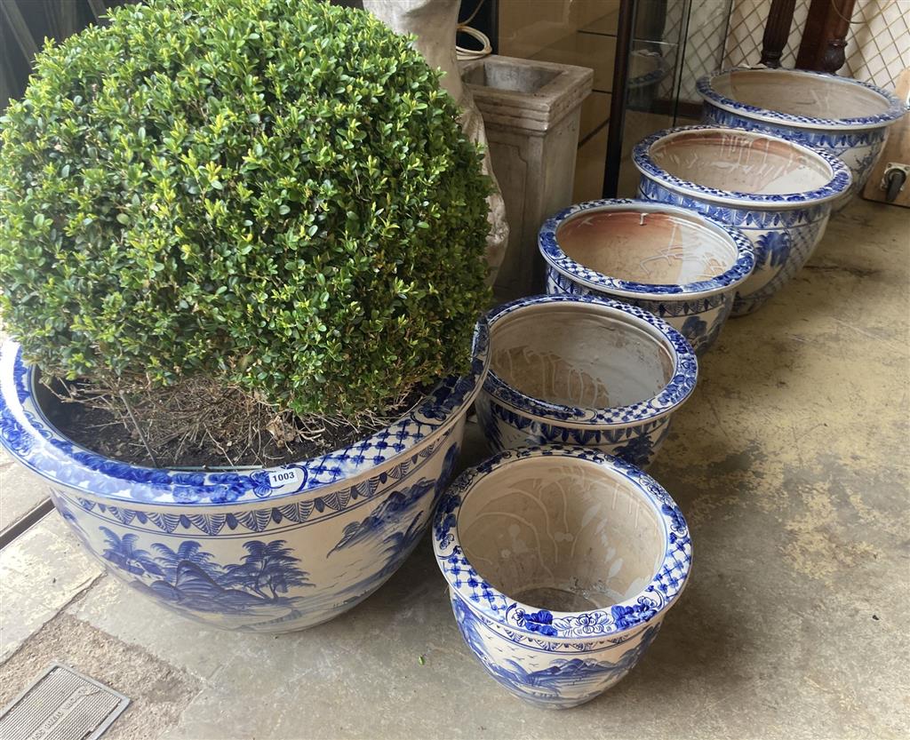 A graduated set of six Chinese style blue and white circular planters, largest width 70cm, height 50cm